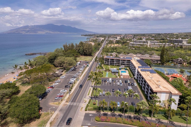 drone / aerial view featuring a water and mountain view