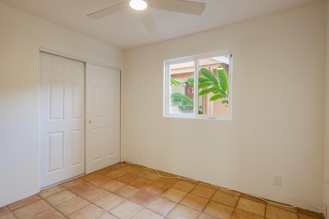 unfurnished bedroom featuring a closet and ceiling fan