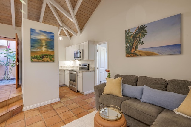 living room featuring beam ceiling, light tile patterned floors, wood ceiling, high vaulted ceiling, and baseboards