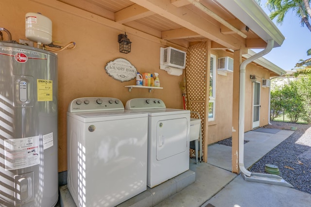 laundry area with a wall mounted AC, water heater, laundry area, and washing machine and clothes dryer