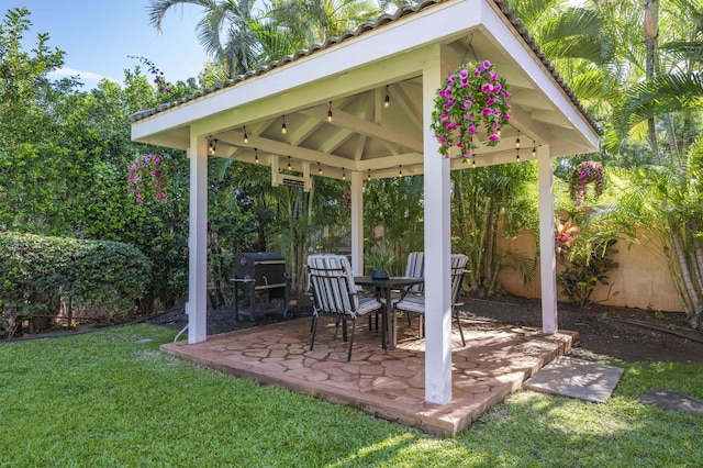 view of patio / terrace with a fenced backyard, grilling area, and a gazebo