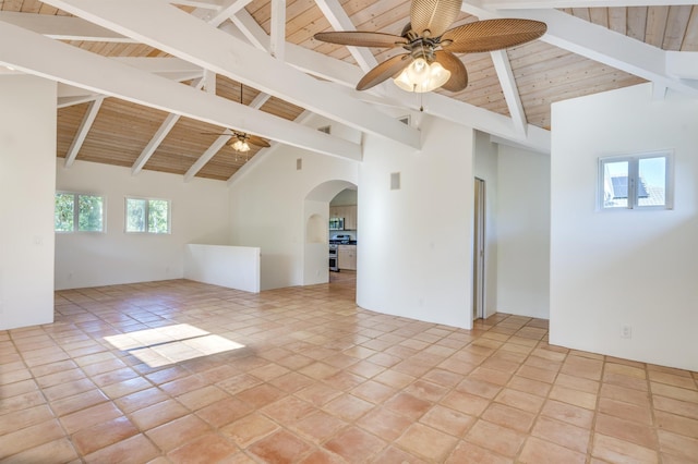 unfurnished room featuring arched walkways, high vaulted ceiling, wooden ceiling, a ceiling fan, and beamed ceiling