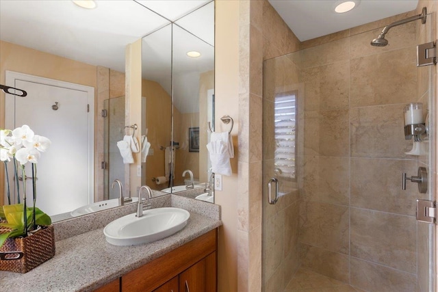 bathroom with an enclosed shower and large vanity