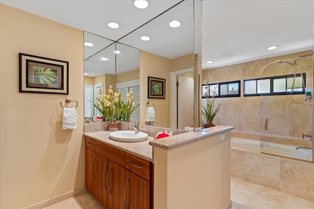 bathroom with tile flooring, vanity, and a wealth of natural light