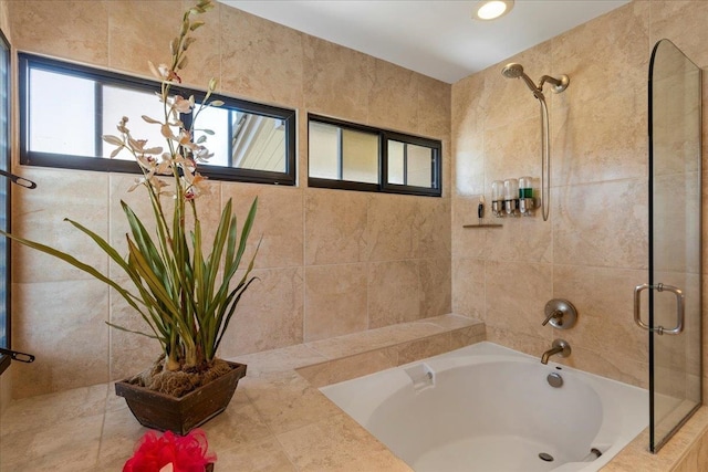 bathroom featuring tile floors and tiled tub