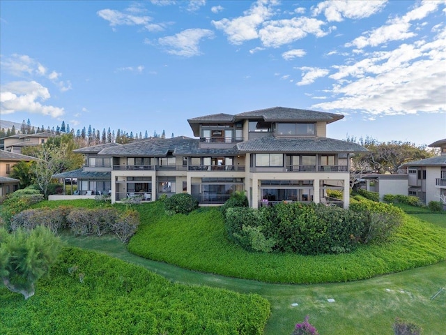 exterior space with a yard and a balcony