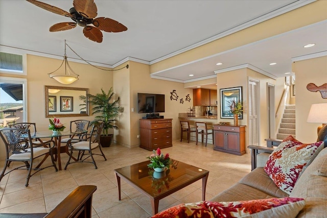 tiled living room with ornamental molding and ceiling fan