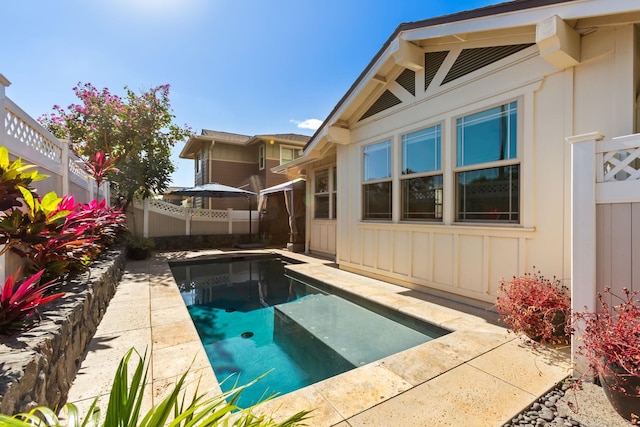 view of pool featuring fence