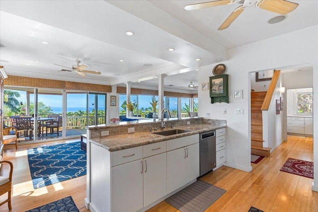 kitchen featuring dishwasher, kitchen peninsula, a healthy amount of sunlight, and sink