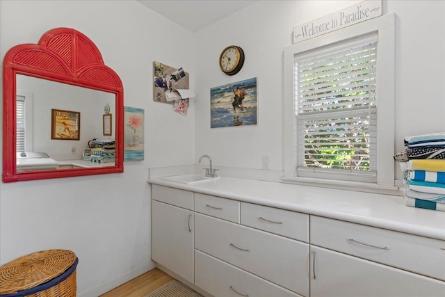 bathroom with vanity and wood-type flooring