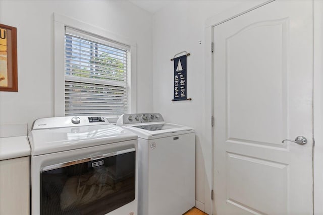 laundry room featuring washing machine and clothes dryer