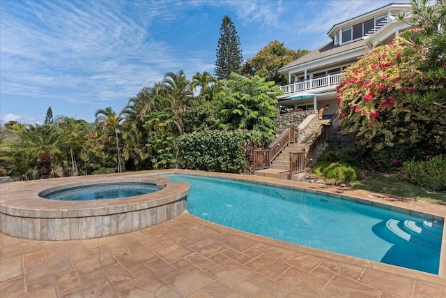 view of pool with an in ground hot tub