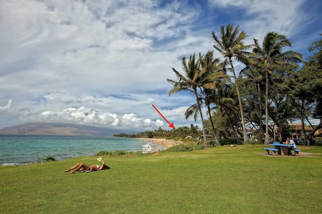 surrounding community with a yard and a water and mountain view