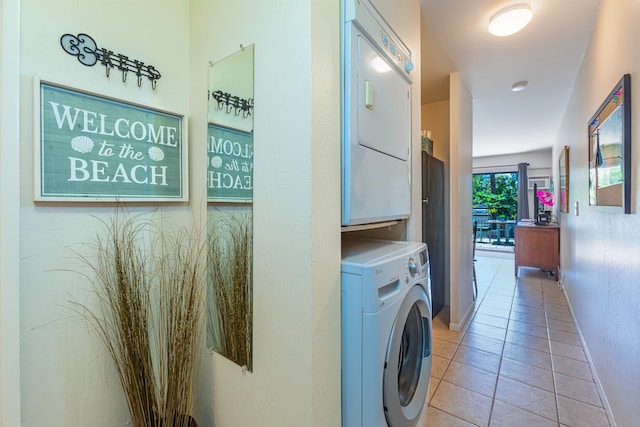 laundry area with light tile patterned flooring and washer / dryer