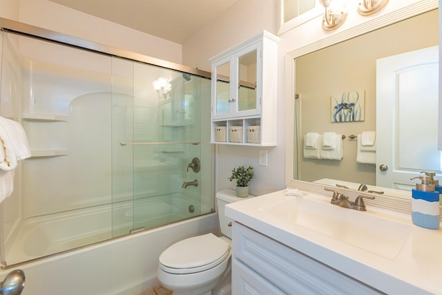 full bathroom with vanity, toilet, and bath / shower combo with glass door