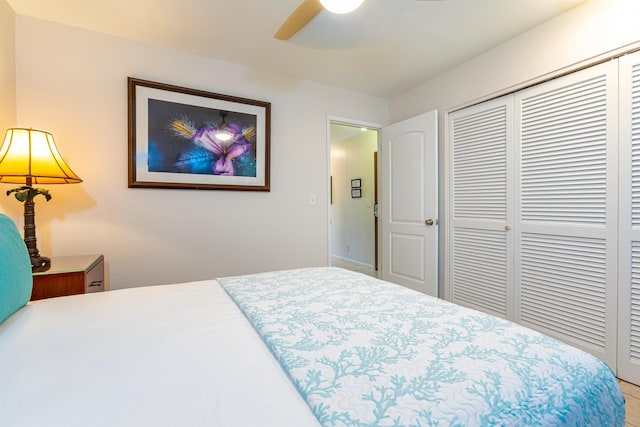 bedroom with ceiling fan and a closet