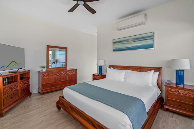 bedroom featuring ceiling fan, light hardwood / wood-style flooring, and a wall mounted AC