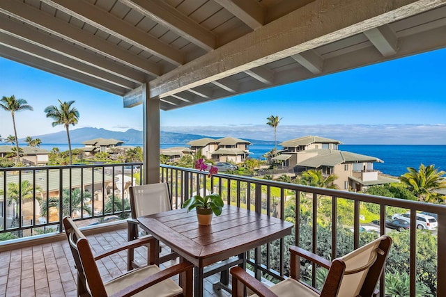 balcony featuring a water and mountain view