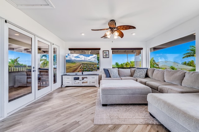 living room with recessed lighting, french doors, light wood-style flooring, and a ceiling fan