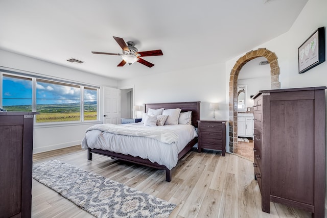 bedroom with ceiling fan, baseboards, visible vents, and light wood-type flooring