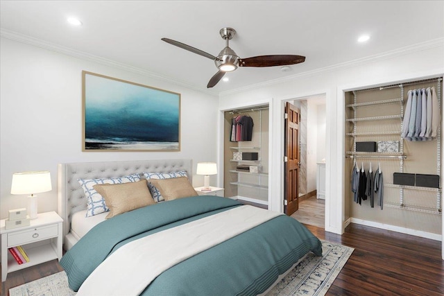 bedroom with crown molding, dark wood-type flooring, ceiling fan, and ensuite bath