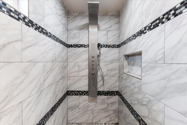 bathroom with a tile shower