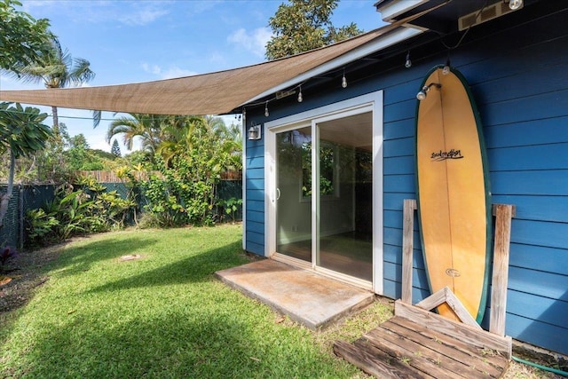 doorway to property with a lawn