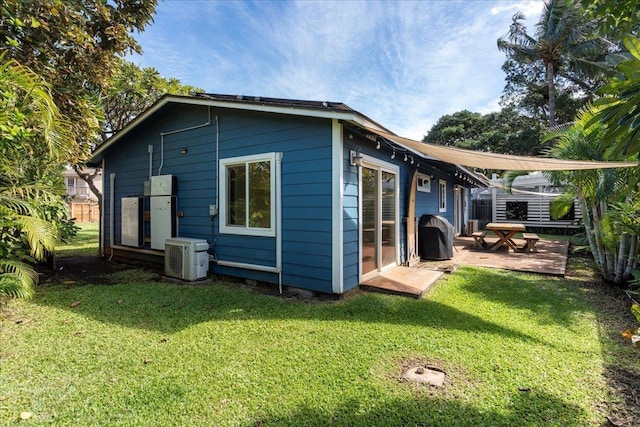 view of property exterior featuring a yard and central AC unit