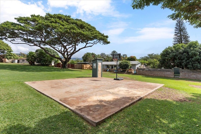 view of basketball court with a lawn