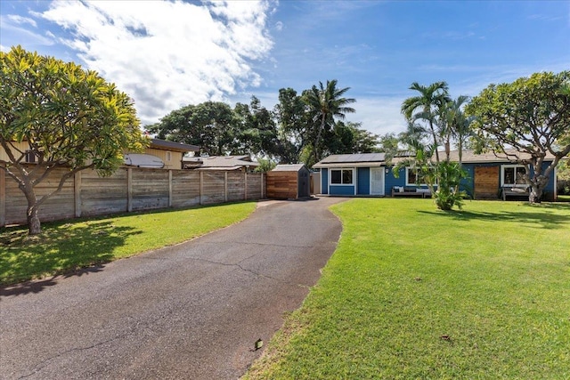 ranch-style home featuring a front yard