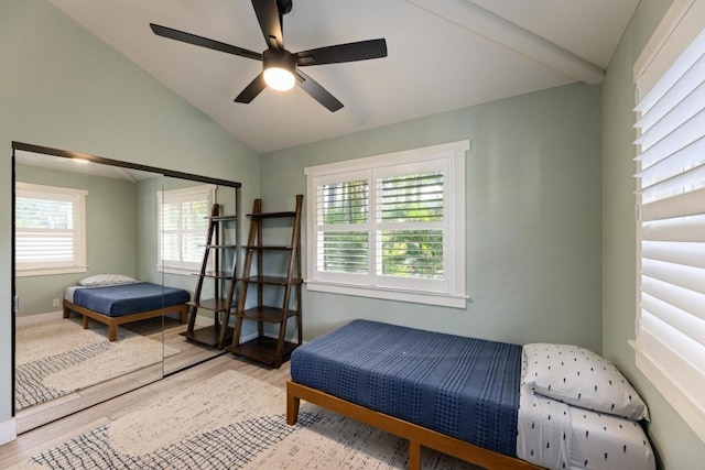 bedroom with ceiling fan, baseboards, wood finished floors, and vaulted ceiling