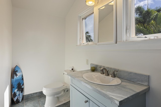 bathroom with a wealth of natural light, toilet, and vanity