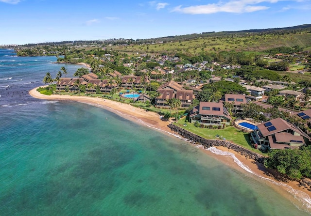 drone / aerial view with a water view and a beach view