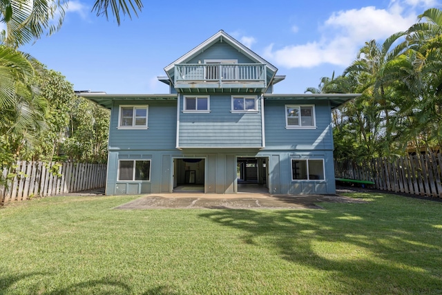 back of house featuring a patio, a lawn, and a fenced backyard