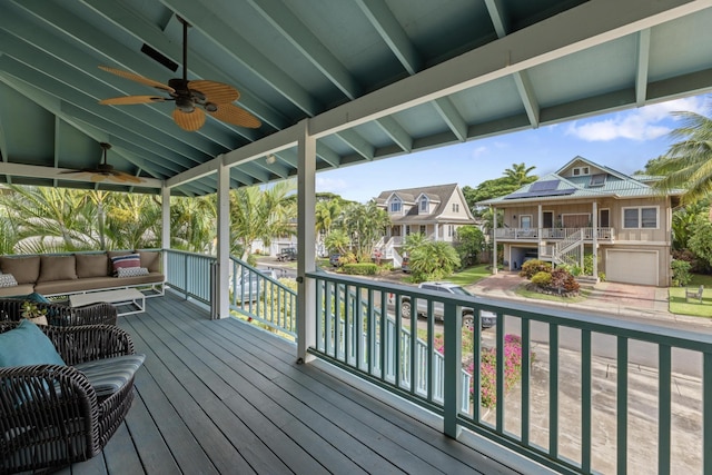 deck featuring an outdoor living space, a residential view, and ceiling fan