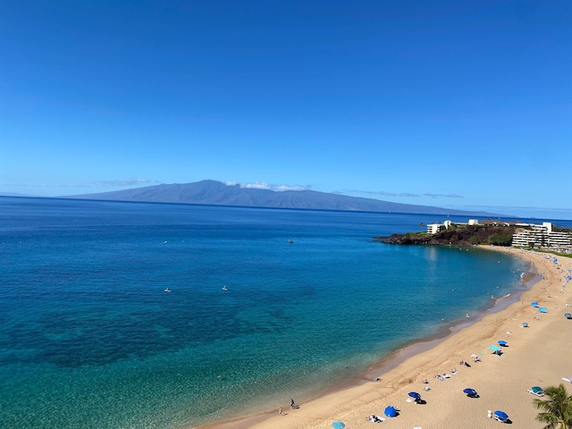 water view featuring a mountain view and a beach view