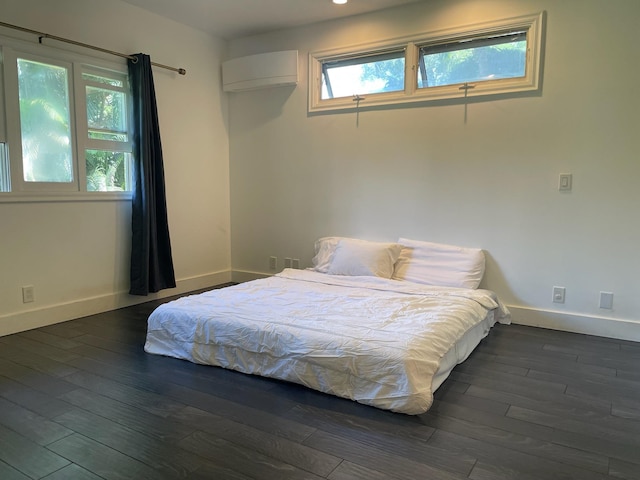55 Palulu Way Unit A, Haiku, HI 96708 - bedroom featuring a wall mounted AC and dark wood finished floors