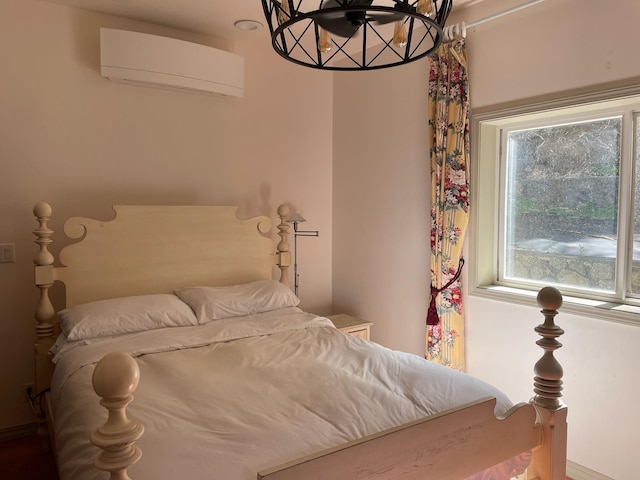 55 Palulu Way Unit A, Haiku, HI 96708 - bedroom featuring a wall unit AC and a chandelier