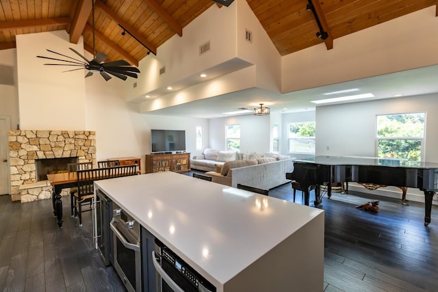 55 Palulu Way Unit A, Haiku, HI 96708 - kitchen with a wood ceiling with exposed beams, open floor plan, dark wood-style floors, stainless steel oven, and a kitchen island