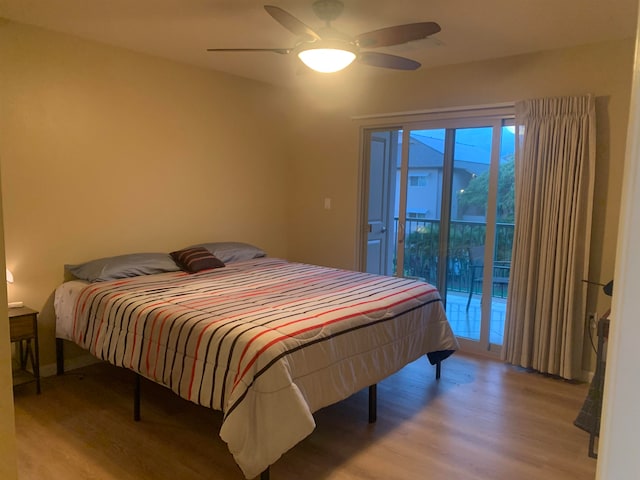 bedroom with access to exterior, light hardwood / wood-style floors, and ceiling fan