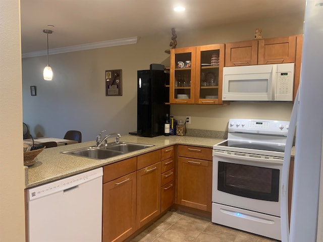 kitchen featuring white appliances, pendant lighting, sink, light tile floors, and ornamental molding