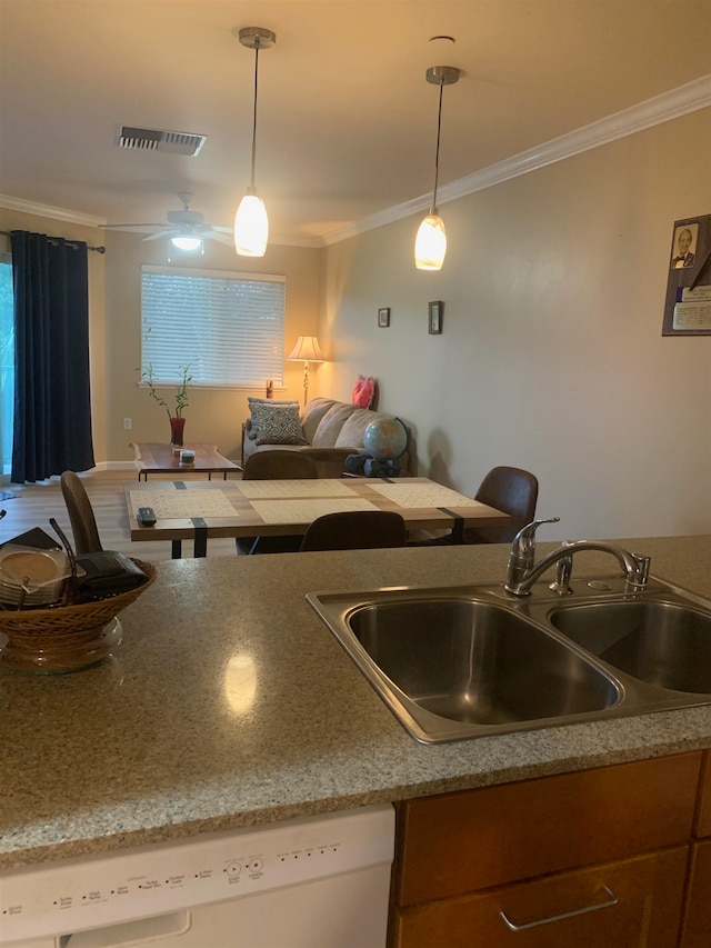 kitchen featuring hanging light fixtures, ceiling fan, dishwasher, and sink