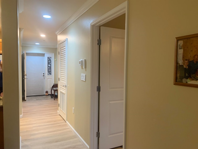 hallway featuring crown molding and light wood-type flooring