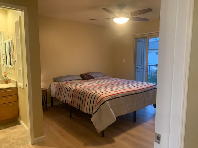 tiled bedroom with ceiling fan and ensuite bathroom