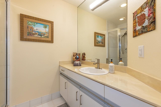 bathroom with tile patterned floors, vanity, and a shower with shower door