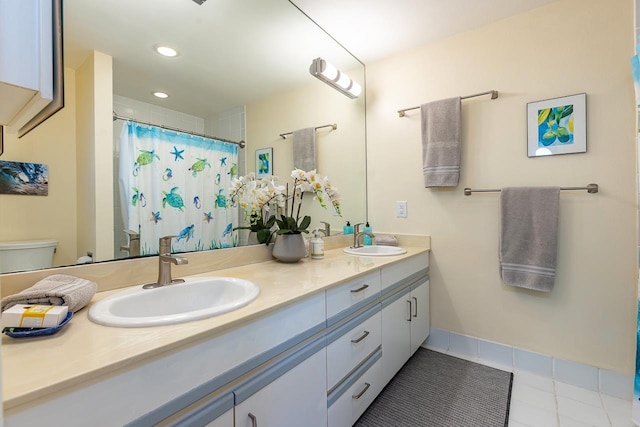 bathroom featuring tile patterned floors, curtained shower, vanity, and toilet