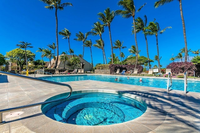 view of pool featuring a hot tub and a patio area