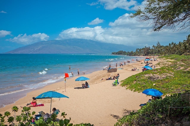 view of water feature featuring a beach view and a mountain view