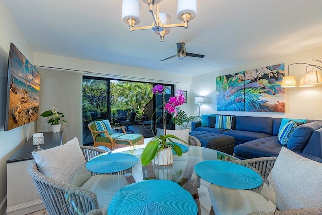 living room with ceiling fan with notable chandelier