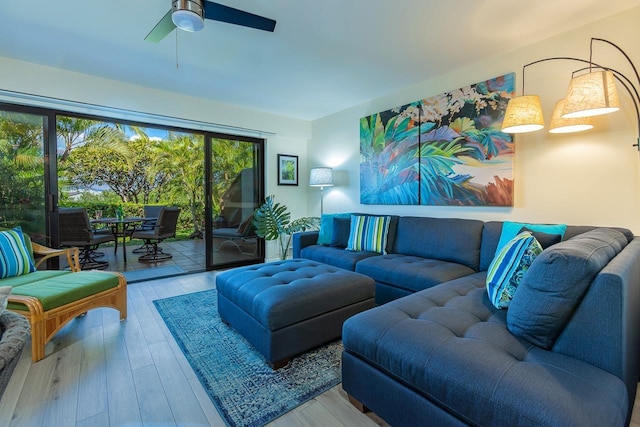 living room with ceiling fan and light wood-type flooring